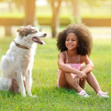 Child and dog in a park.