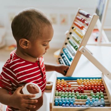 Toddler playing with toys at a daycare center.