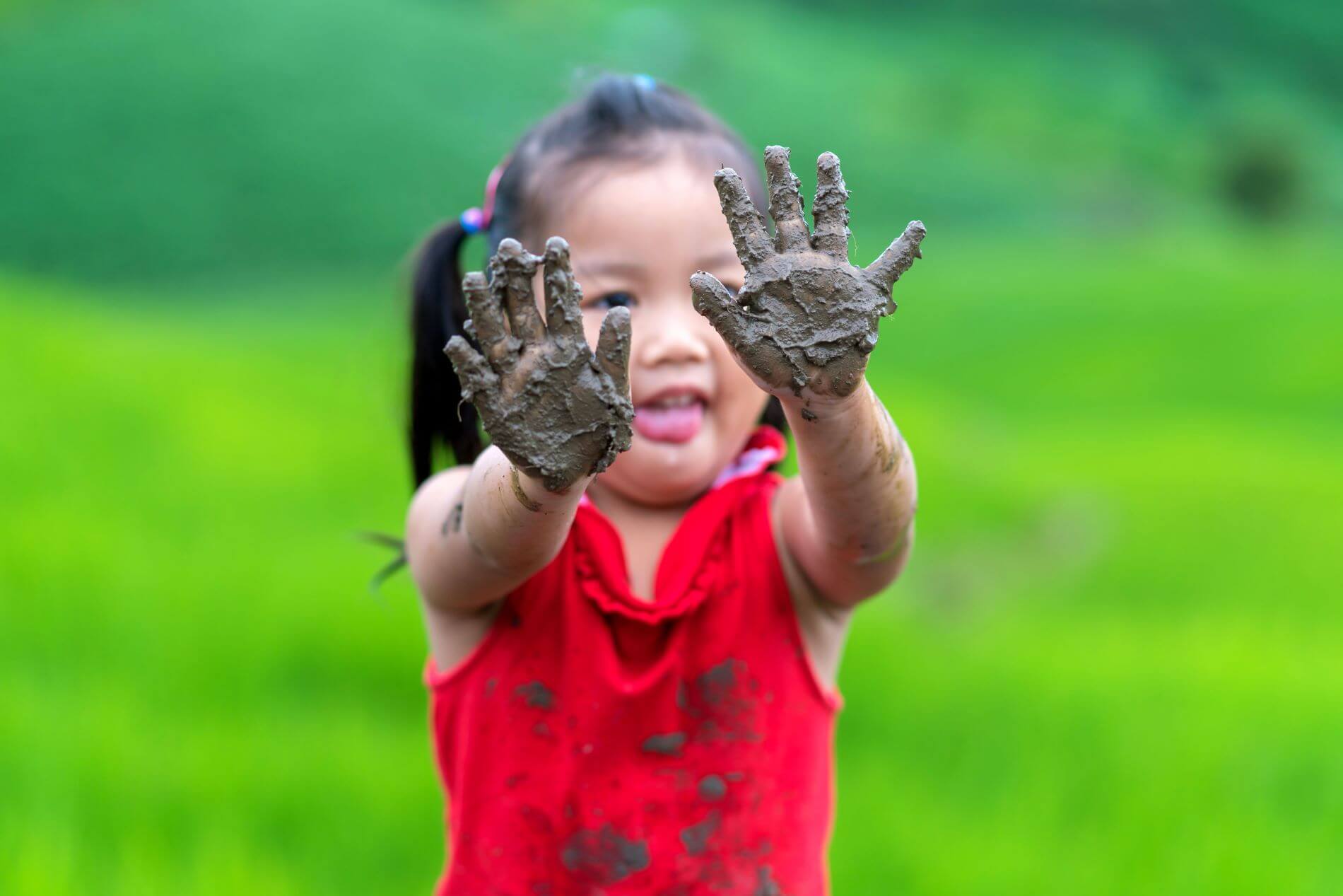 Kid playing with mud.