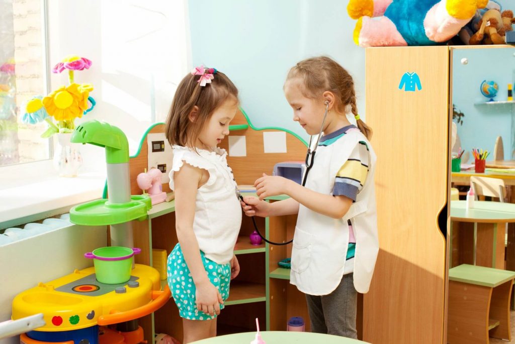 Two kids playing doctor at a school.