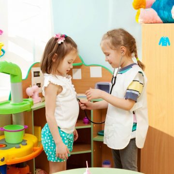 Two kids playing doctor at a school.