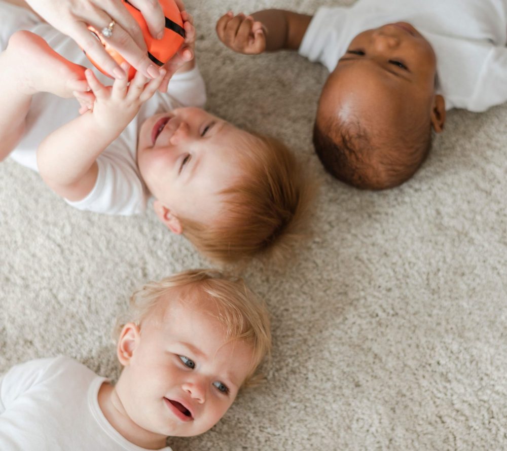 Three infants on floor