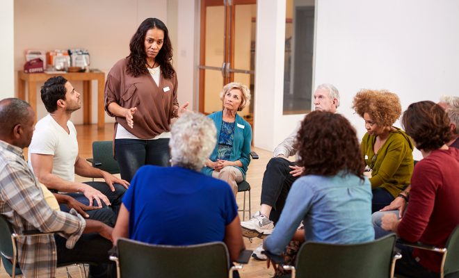 Woman standing To address group meeting in community center