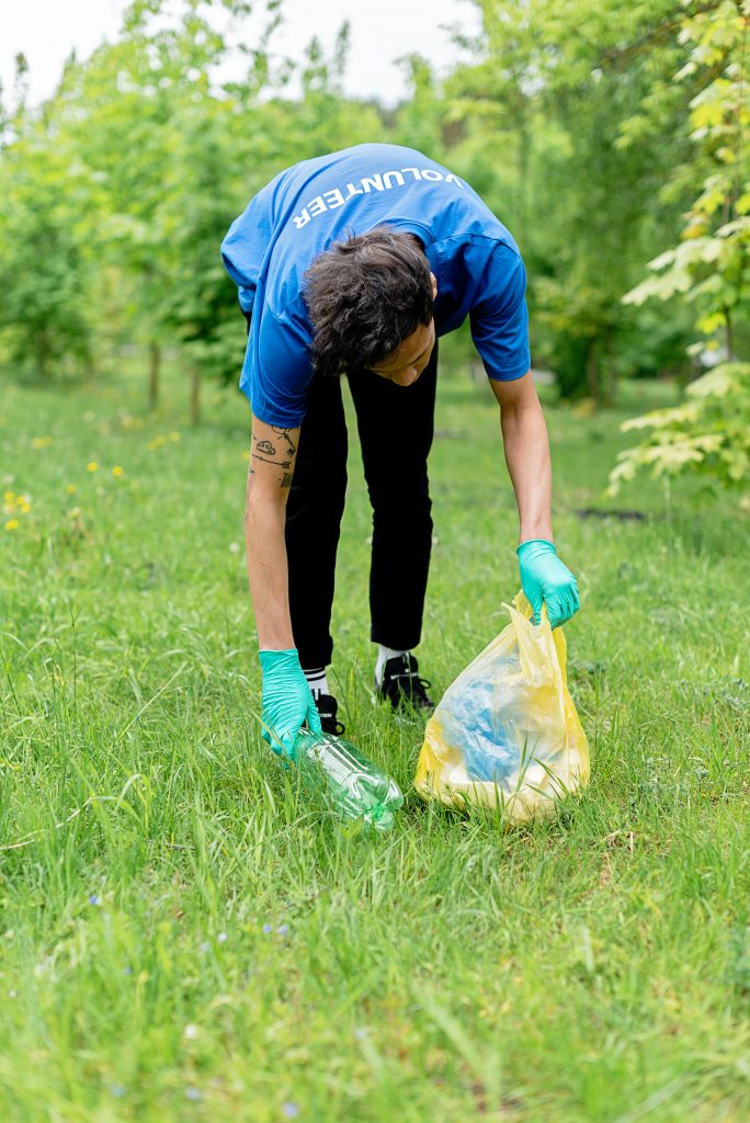 Volunteer cleaning up park.