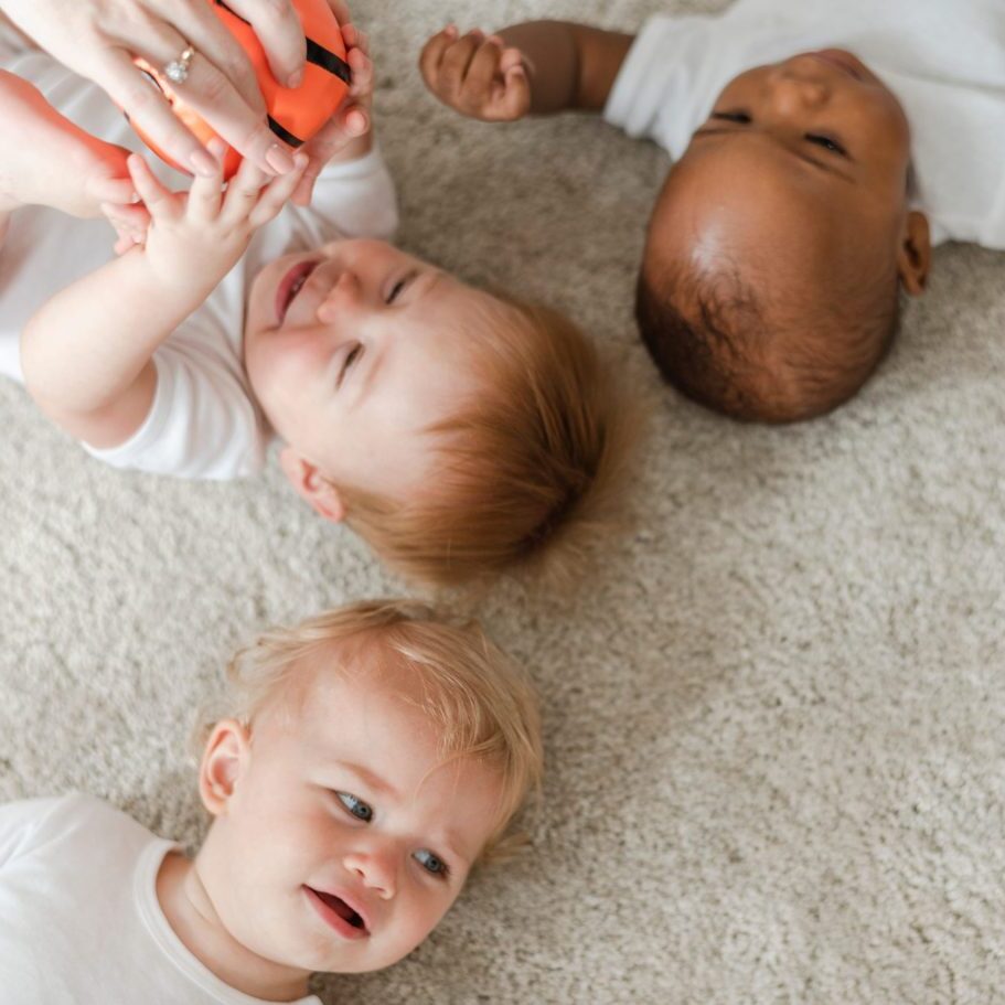 Three infants on floor