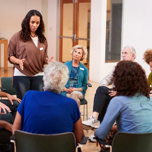 Woman standing To address group meeting in community center
