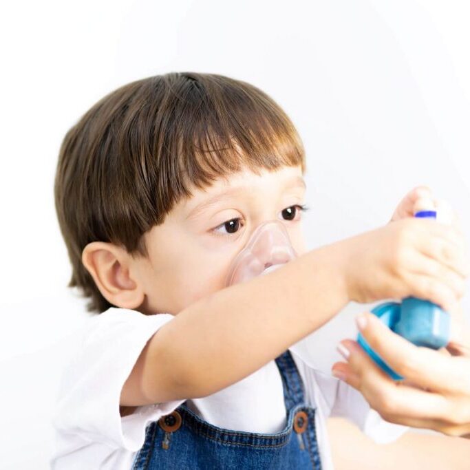 Child using inhaler.