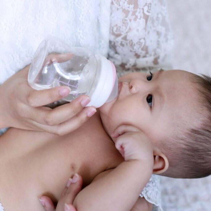 Baby drinking from a bottle.