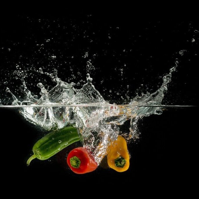 Fruits and vegetables dunked in water.