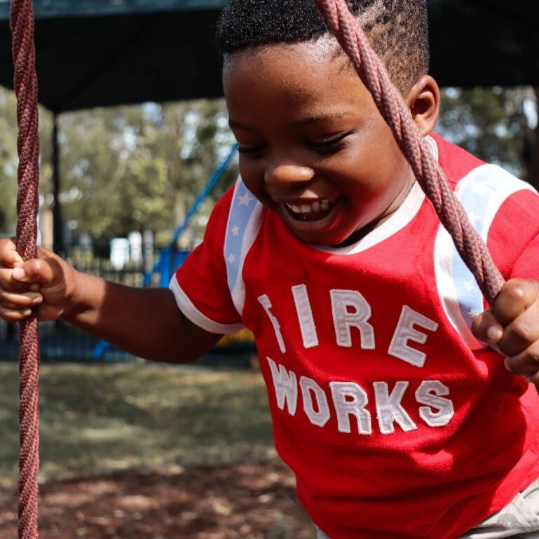 Child on tire swing.